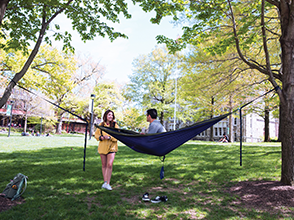 students relaxing in a hammock