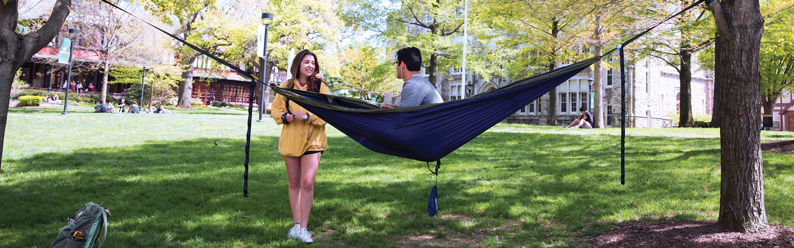 students relaxing in a hammock