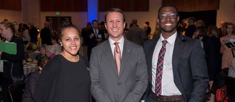 group of three people at an event